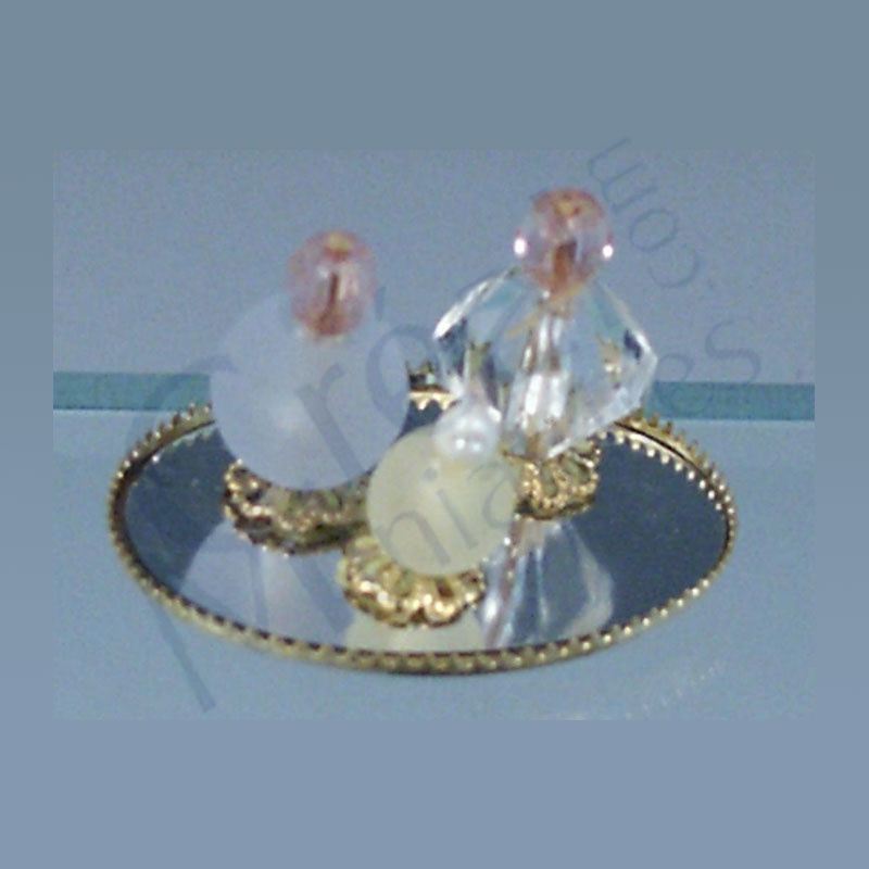 3 perfumes on oval mirror